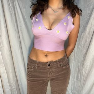 Purple crop top with daisy embroidery.
